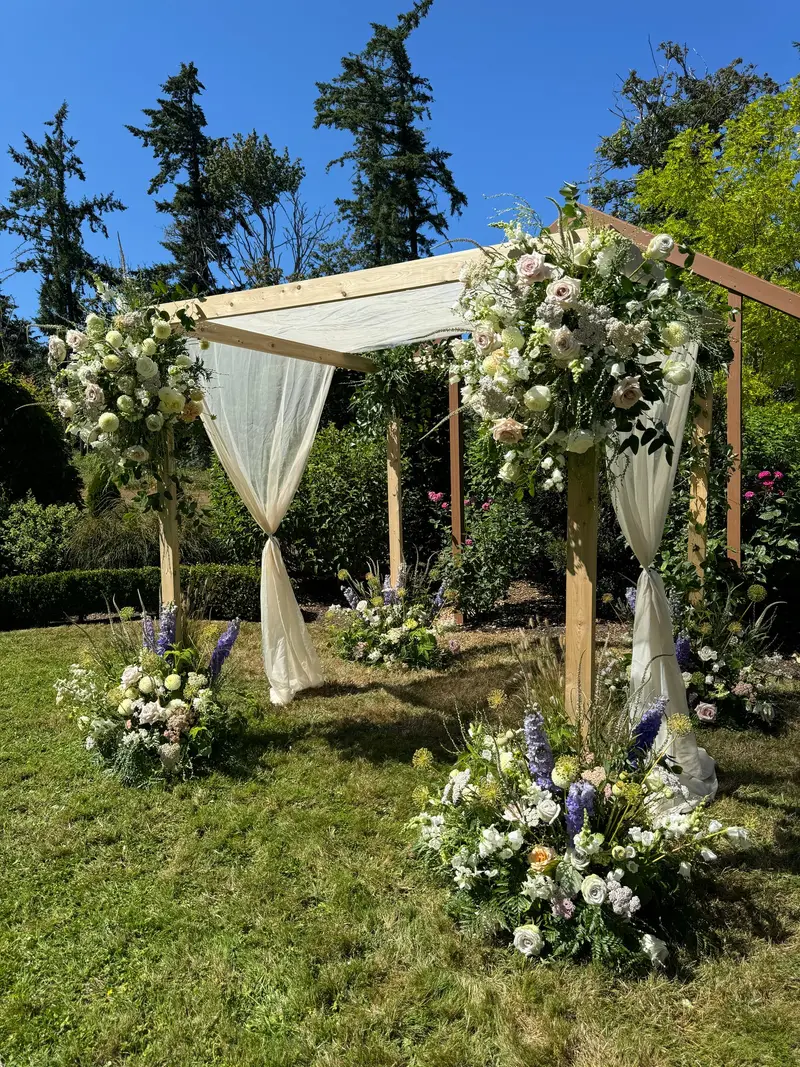 The Traditional Chuppah — Denver cedar chuppah rental with ivory linen drape and floral base arrangements